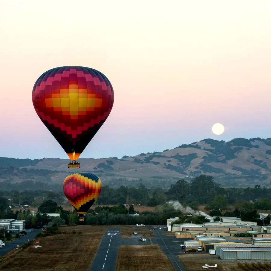 Balloons over Sonoma Skypark at moonset