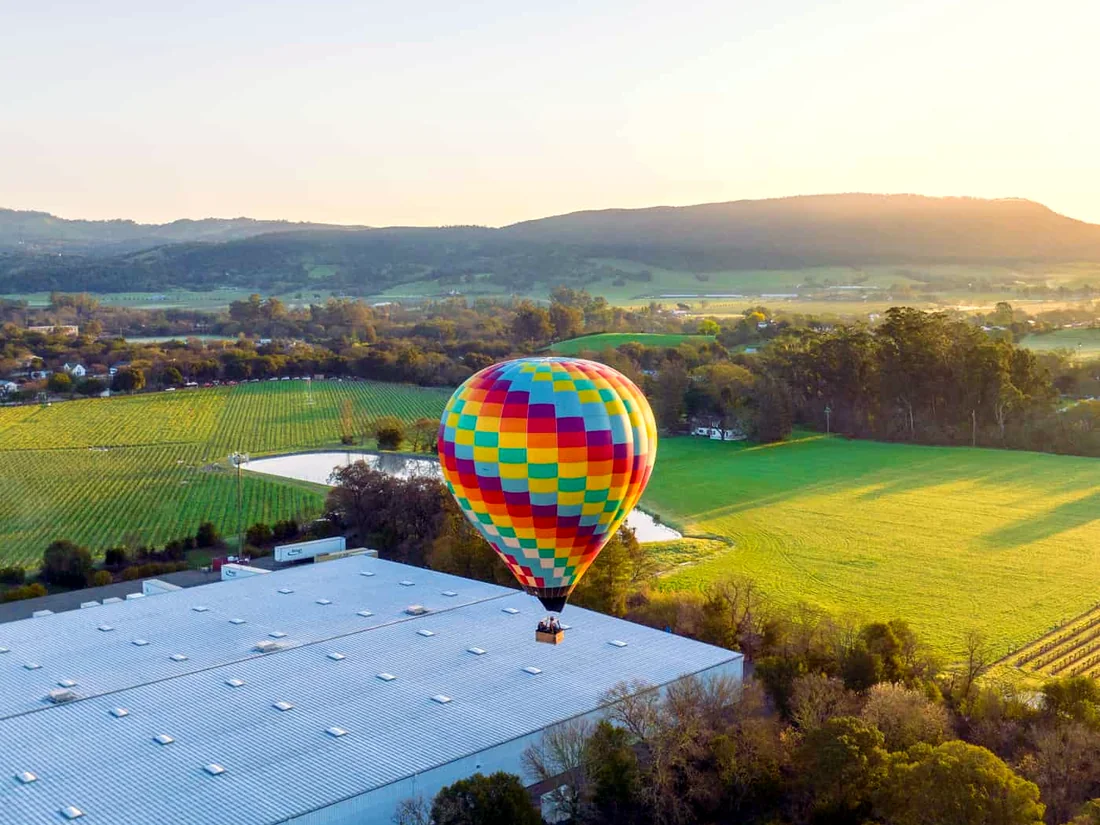 Balloon drifting over a wine country estate