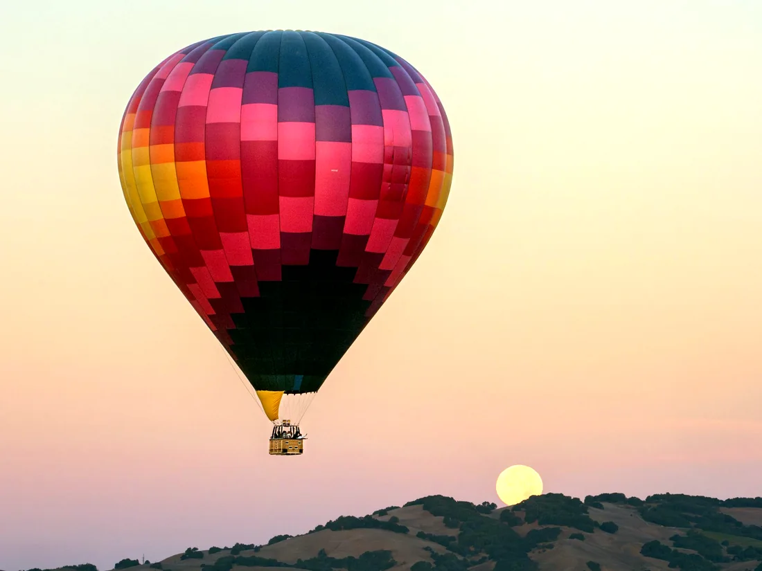 Balloon at dawn with the moon setting — wedding flight
