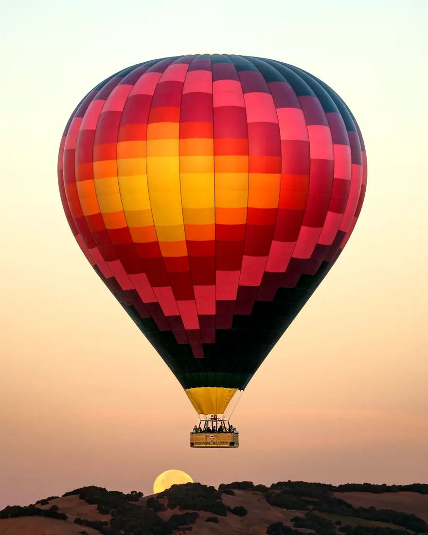 Sonoma Ballooning balloon at altitude with the moon on the horizon